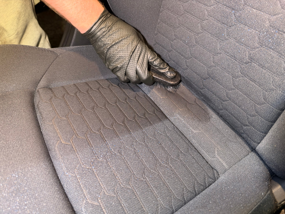 Interior ceramic coating being worked into the fabric seats